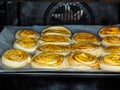 Closeup of raw cinnamon buns after proofing with egg yolk