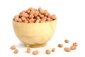 Closeup raw peanuts seed on brown wooden bowl isolated / cutout in white background with studio lighting
