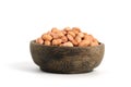 Closeup raw peanuts on wooden bowl isolated white background Royalty Free Stock Photo