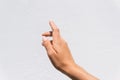 Closeup of reaching out hand sign against a white wall background Royalty Free Stock Photo