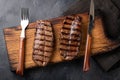 Closeup ready to eat steak Top Blade beef breeds of black Angus with grill tomato, garlic and on a wooden Board. The Royalty Free Stock Photo