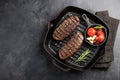 Closeup ready to eat steak Top Blade beef breeds of black Angus with grill tomato, garlic and on a wooden Board. The Royalty Free Stock Photo