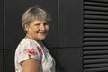 Closeup Real Smiling Senior Old 70s Woman, Dark Wall on Background. Portrait Of Kind Happy Royalty Free Stock Photo