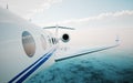 Closeup of realistic photo white, luxury generic design private jet flying over the ocean.Modern airplane and clouds in a sky on Royalty Free Stock Photo