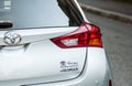 Closeup of rear light and sign of grey Toyota Auris parked in the street