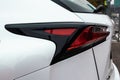 Closeup of rear red taillight on white suv. Back lights of modern car Royalty Free Stock Photo