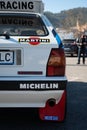 Closeup of the rear view of a Lancia Delta HF covered in stickers parked on the street