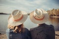 Closeup rear view of man and woman sitting on the beach and loo