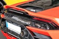 Closeup rear view of an orange Lamborghini Huracan showing the exhaust pipes