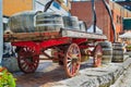 Closeup rear view of vintage classic horse drawn carriage loaded with wooden barrels