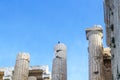 Closeup of reconstructed pillars on Acropolis in Athens Greece with old and new parts fits together - bird perched on top of