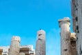 Closeup of reconstructed pillars on Acropolis in Athens Greece with old and new parts fits together - bird perched on top of