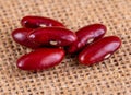 Closeup red beans or kidney bean in wooden bowl isolated on wood table background Royalty Free Stock Photo