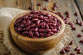 Closeup red beans or kidney bean in wooden bowl isolated on wood table background Royalty Free Stock Photo