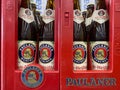 Closeup of red beer crate with logo lettering of bavarian paulaner brewery in german supermarket