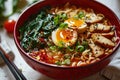 closeup red bowl of delicious ramen with pork on a white table, tasty traditional asian noodle soup Royalty Free Stock Photo