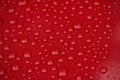 Closeup red car paint surface with hydrophobic ceramic coating
