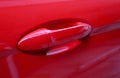 Closeup a red car`s door outside handle Royalty Free Stock Photo