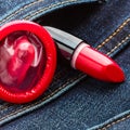 Closeup red condom on jeans pocket.