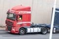 Closeup of a Red DAF XF truck loading a container trailer along Barcelona's Ronda Litoral