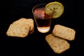 Red aperitif drink with lemon slice and salty crackers Royalty Free Stock Photo