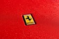 a ferrari badge on a red sports car closeup on its hood Royalty Free Stock Photo