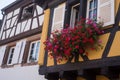 red geraniums at he window of a medieval house facade Royalty Free Stock Photo