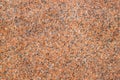 Closeup of a red granite stone surface. Texture of a polished natural crystalline rock as a background Royalty Free Stock Photo