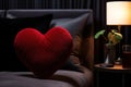 closeup red heart shaped pillow on black silk bed in bedroom Royalty Free Stock Photo