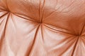 Closeup of red leather recliner chair backrest