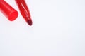 Closeup of a red marker with the cap off isolated on a white background Royalty Free Stock Photo