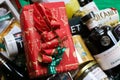 Closeup of red package box wrapped in red Christmas paper in gift hamper basket with whole food products Royalty Free Stock Photo