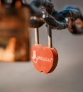 Closeup of a padlock hanging on chain link of the bridge / Fence Royalty Free Stock Photo