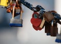 Closeup of a padlock hanging on chain link of the bridge / Fence Royalty Free Stock Photo