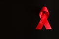 Closeup red ribbon awareness on black background for World Aids day Royalty Free Stock Photo