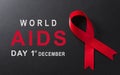 Closeup red ribbon HIV, world AIDS day awareness ribbon on black background. Healthcare and medicine concept Royalty Free Stock Photo