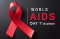 Closeup red ribbon HIV, world AIDS day awareness ribbon and the text on black background. Healthcare and medicine concept Royalty Free Stock Photo