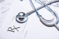 Closeup of a red stethoscope on a rx prescription. Royalty Free Stock Photo