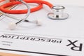 Closeup of a red stethoscope on a rx prescription. Royalty Free Stock Photo
