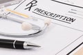 Closeup of red stethoscope, thermometer and pen on a rx prescription. Royalty Free Stock Photo