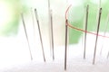 Closeup red thread put into silver Needle with beauty bokeh lighting Royalty Free Stock Photo