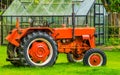 Closeup of a red tractor at the barn, Agricultural transport and equipment, Farm machinery Royalty Free Stock Photo