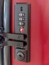 A closeup of a red travel suitcase with combination lock. Royalty Free Stock Photo