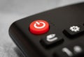 Closeup of the red turn off button on a remote control under the lights Royalty Free Stock Photo