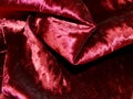 Closeup of red velvet - like fabric, polyester, viscose, clothing, ecological Royalty Free Stock Photo