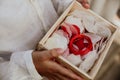 Closeup of a red wedding cord in a wooden box