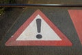 Closeup of red white old vintage caution sign painted on asphalt between rails - Germany Royalty Free Stock Photo