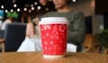 Closeup Red and White Paper Coffee Cup with Blurry People in the Backdrop