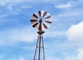 A closeup of a red and white windmill