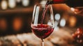 Closeup of red wine being poured into a glass at a stylish and sophisticated upscale restaurant